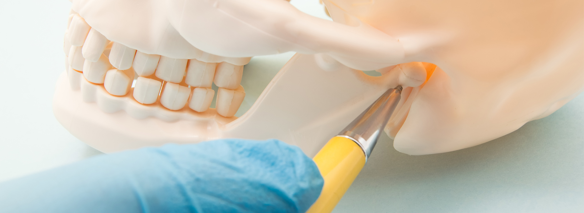 The image shows a close-up of a dental implant being placed in a patient s mouth, with a surgical tool and a yellow instrument visible.